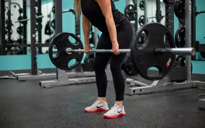 Women lifting large barbell